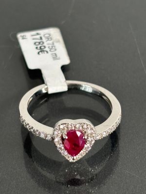 an image of a heart shaped ruby and diamond ring on a black surface