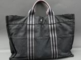 a black and white striped tote bag sitting on top of a table