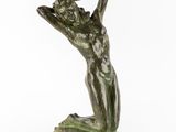 a bronze statue of a woman holding her hands up to her head