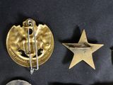 several different types of military badges are displayed on a black surface