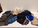 a pile of clothes sitting on a table in a room