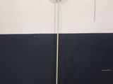 un lampadaire blanc muni d'une lampe circulaire