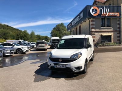 a white van parked in front of a building in a parking lot