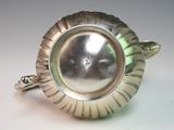 silver plated ring with a flower design on the center of it