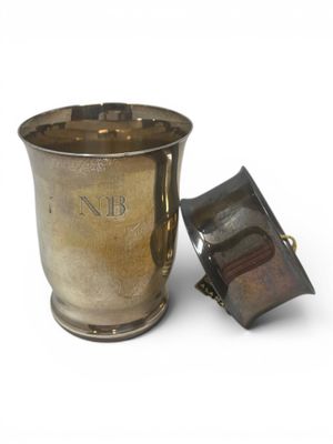 a silver cup with a lid sitting next to a lighter