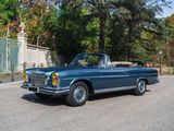 a blue car that is driving down the street