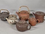 many different types of teapots and teapots on the table