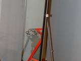 a mirror in the corner of a room with a ladder