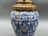 an image of a blue and white vase with a gold lid