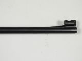 a close up of a gun on a white surface