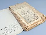 an old book with writing on it sitting on top of a table