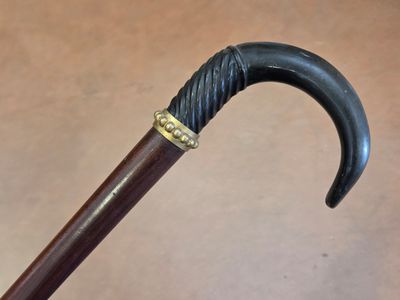 a close up of a cane with a black handle