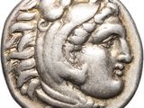 a silver coin with a head of a woman on it