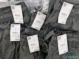 several pairs of pants with price tags on them sitting on a table