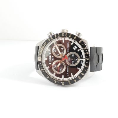 a close up of a watch on a white surface