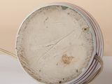 a close up of a plate with a handle on a table