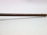 a close up of a wooden stick on a white surface