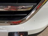 a close up of a person holding a remote control in front of a car