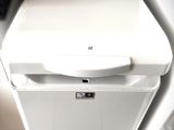 a white dishwasher sitting on top of a washer dryer