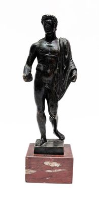 statue of a man holding a cloth on a wooden base