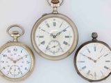 three different types of pocket watches are displayed on a white surface