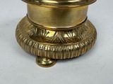 a gold plate with a lid on a white surface