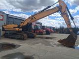 an image of a large excavator parked outside of a building