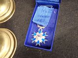 a blue box with a silver medal and a blue ribbon
