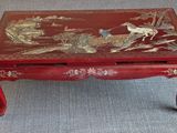 a red coffee table with a bird design on it