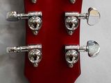the headstock of an electric guitar with a red body