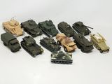 a lot of toy army vehicles that are on the table