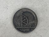 a coin with a clock on it on a white surface