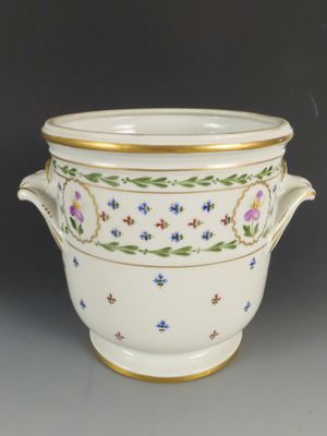 un grand bol blanc orné d'un liseré doré et de motifs floraux