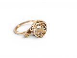 an image of a gold ring with a flower design on it