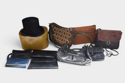 many different purses and wallets laid out on a table