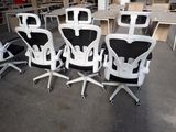 four office chairs that are sitting in the middle of a room