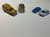 three toy cars that are sitting on a table