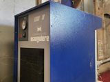 a blue machine that is sitting on a wooden table