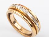 an 18k yellow gold ring with baguets and diamonds