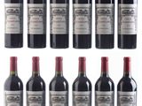 several bottles of wine are lined up on a white surface