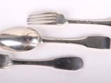 three forks and two spoons on a white surface