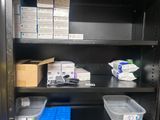 many boxes and containers on the shelves in the room