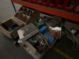 a pile of assorted items sitting on the floor in a warehouse