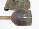 two shovels and a pouch on a table