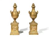 pair of antique brass vases on pedestals on a white background