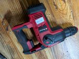 a corded drill and a hammer on a wooden floor