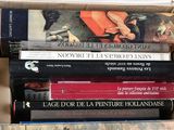 a lot of books that are stacked on top of each other