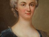 portrait of a woman in a blue dress with a flower in her hair