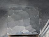a piece of metal on top of a metal table