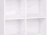 a close up of a white bookcase with four shelves